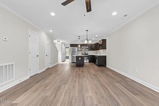 a view of a kitchen with furniture and a ceiling fan