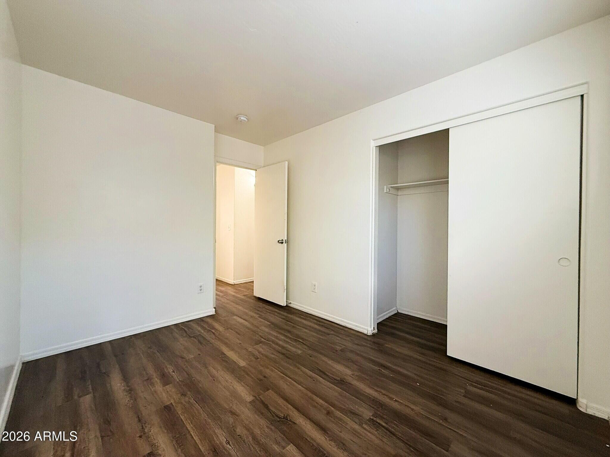 10010 North 7th Avenue, Unit 2 Phoenix, AZ 85021 - Photo 14 of 21 a view of an empty room with wooden floor
