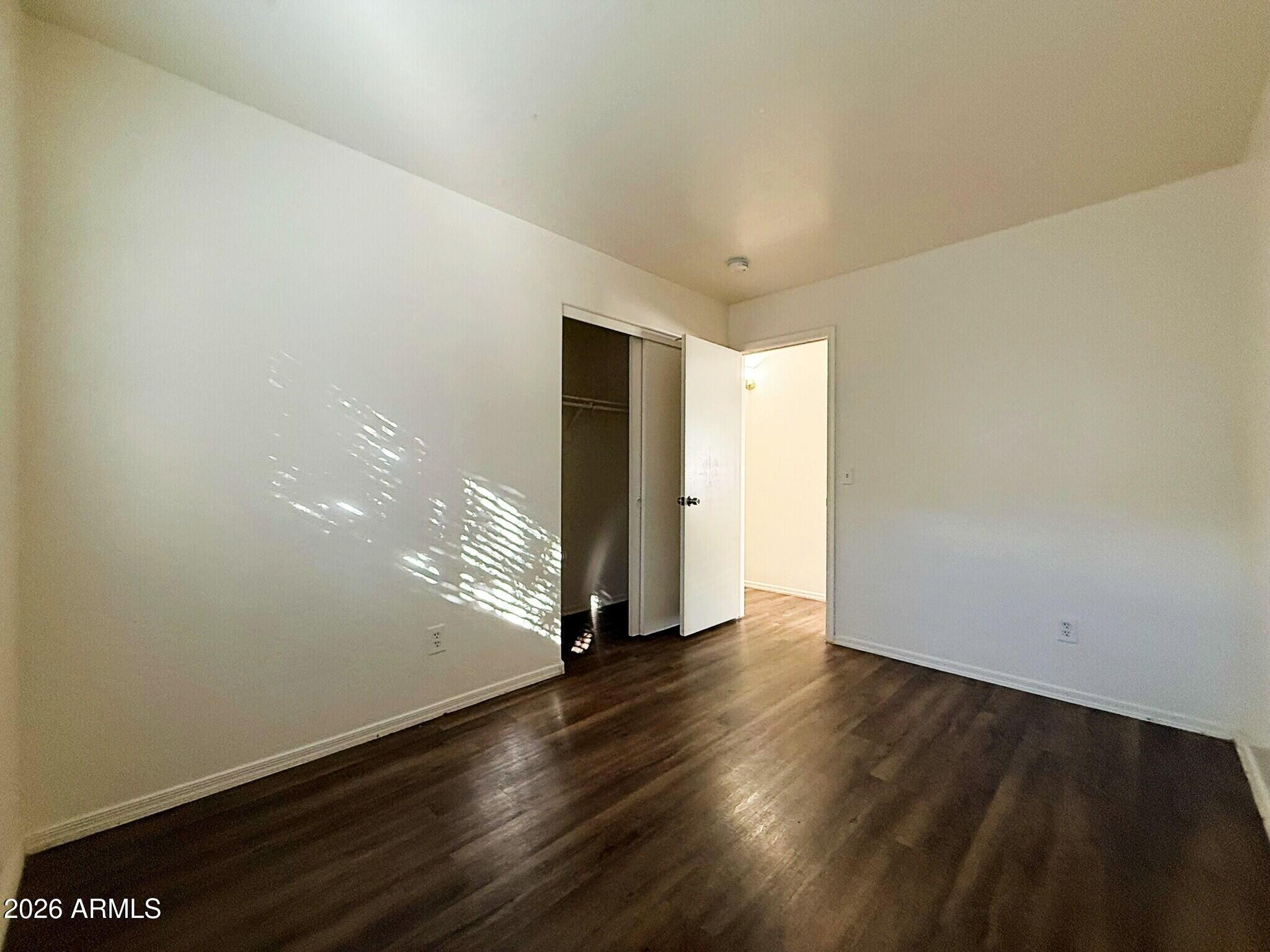 10010 North 7th Avenue, Unit 2 Phoenix, AZ 85021 - Photo 18 of 21 a view of an empty room with wooden floor