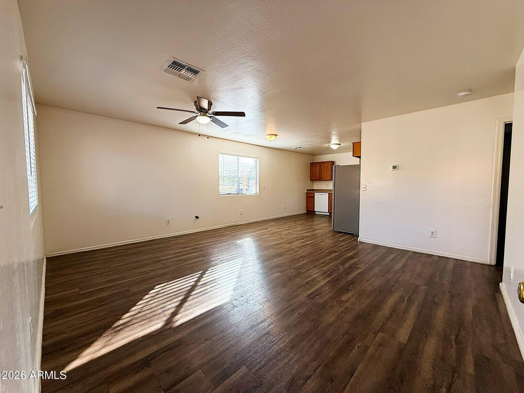 10010 North 7th Avenue, Unit 2 Phoenix, AZ 85021 - Photo 3 of 21 wooden floor in an empty room with a window