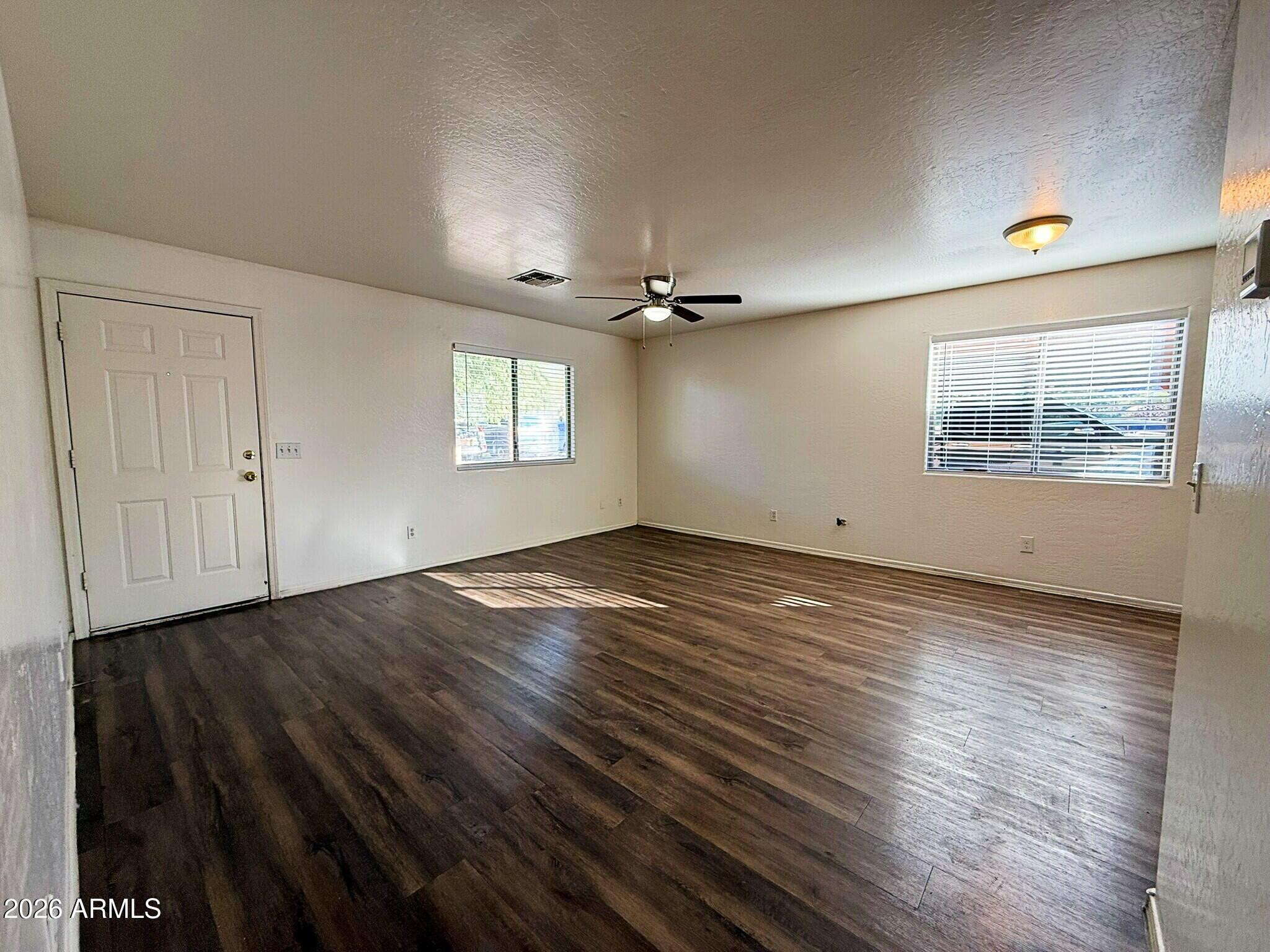 10010 North 7th Avenue, Unit 2 Phoenix, AZ 85021 - Photo 4 of 21 an empty room with wooden floor and windows