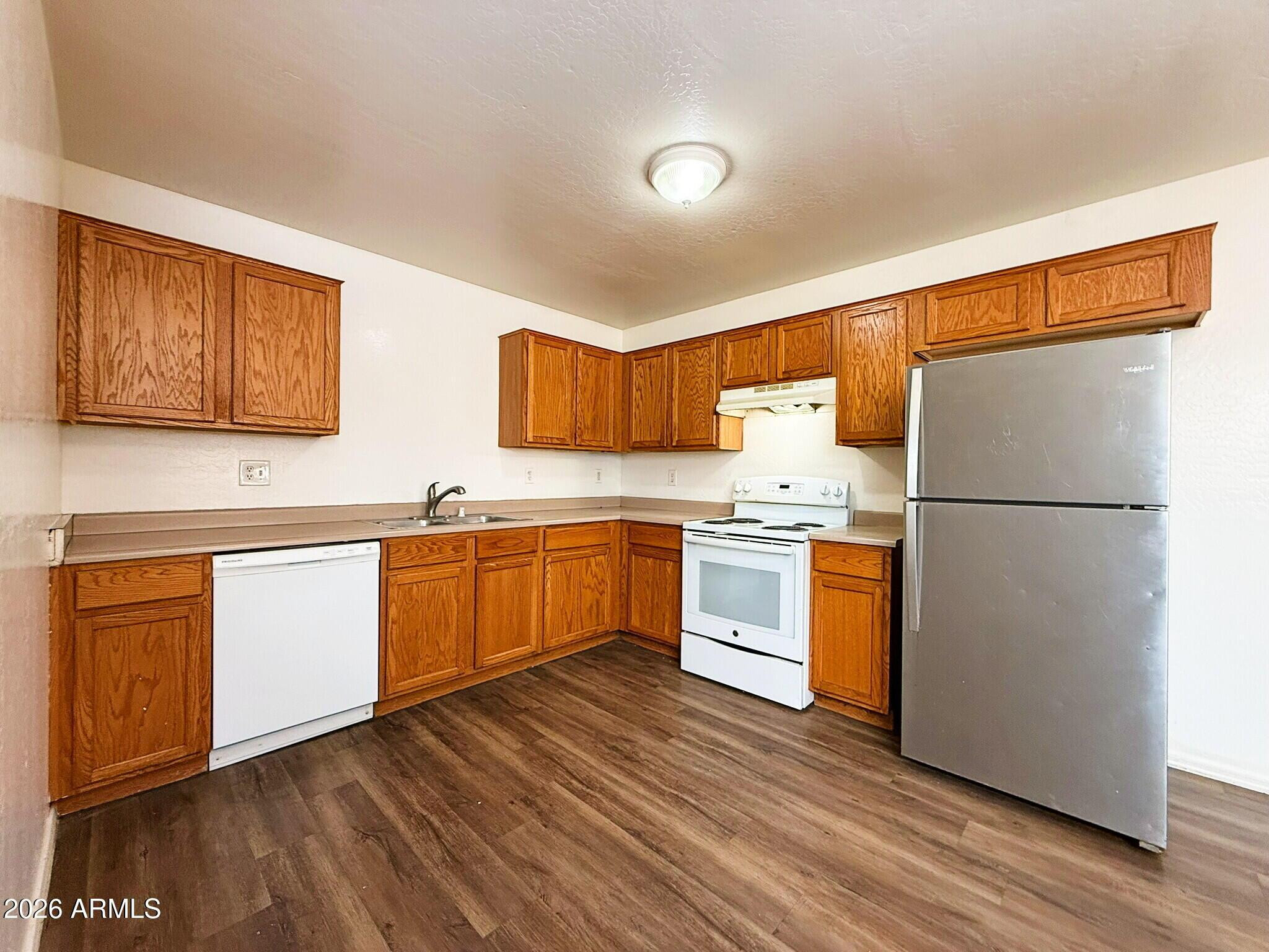 10010 North 7th Avenue, Unit 2 Phoenix, AZ 85021 - Photo 6 of 21 a kitchen with granite countertop white cabinets and white appliances
