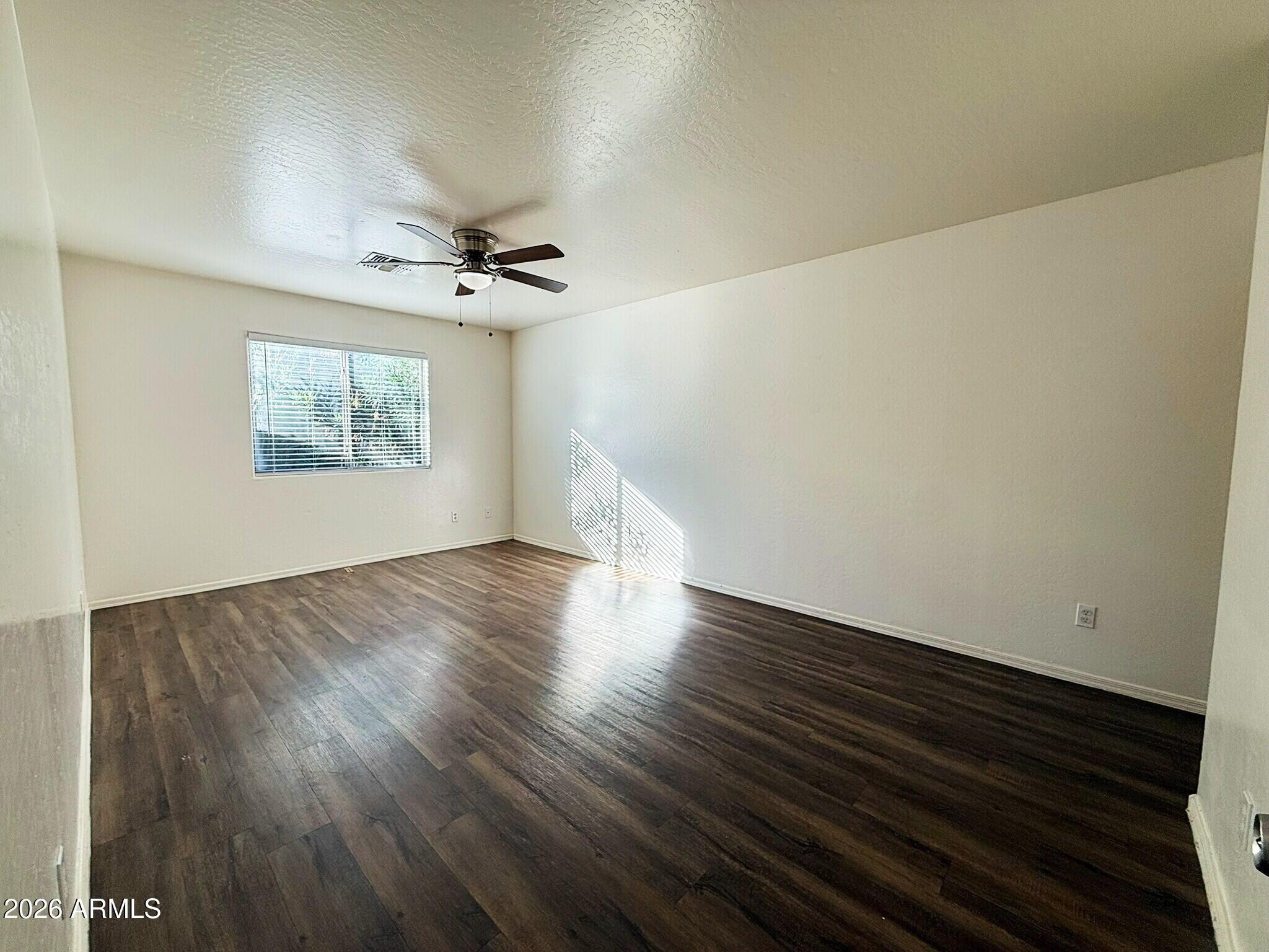 10010 North 7th Avenue, Unit 2 Phoenix, AZ 85021 - Photo 8 of 21 wooden floor in an empty room with a window