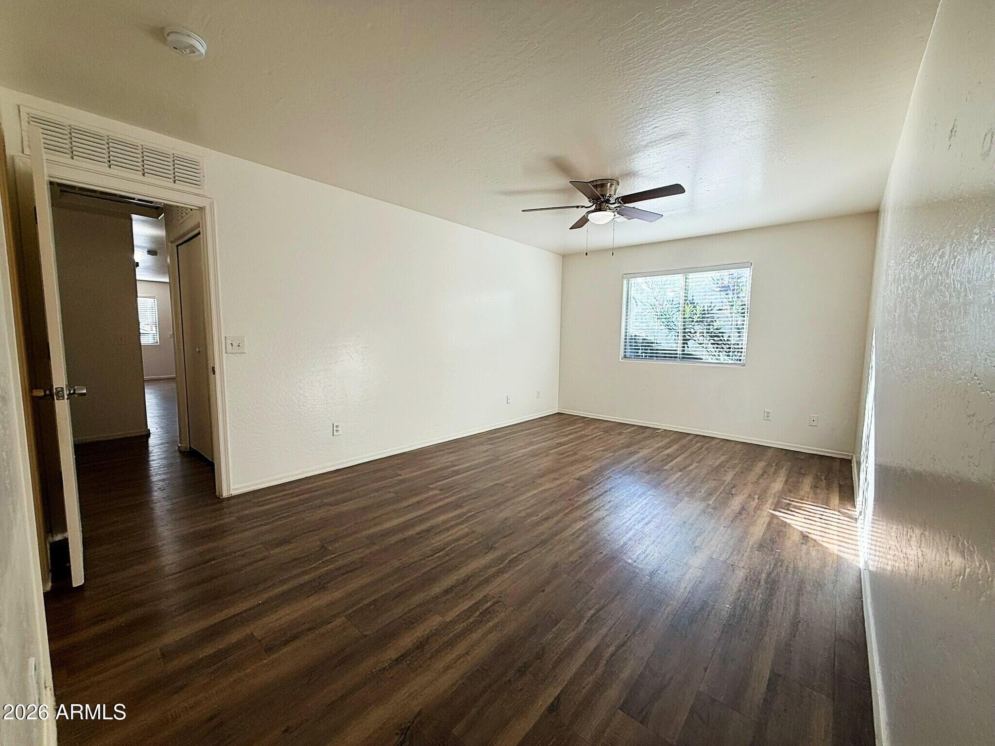 10010 North 7th Avenue, Unit 2 Phoenix, AZ 85021 - Photo 9 of 21 wooden floor in an empty room with a window