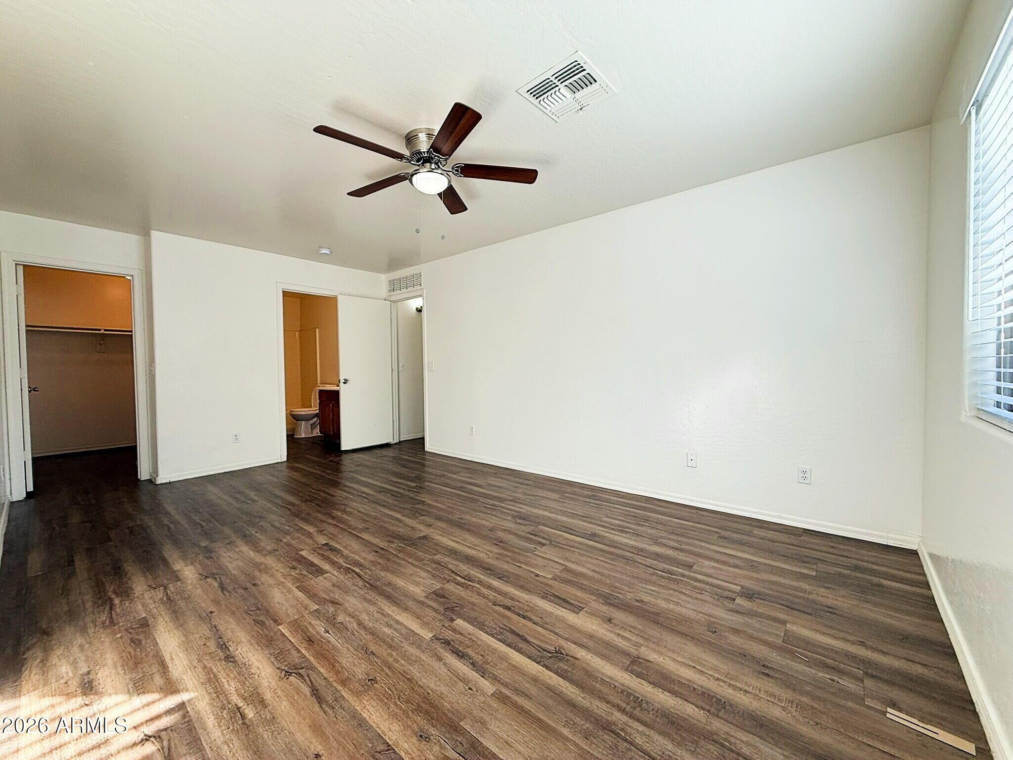 10010 North 7th Avenue, Unit 2 Phoenix, AZ 85021 - Photo 10 of 21 a view of empty room with wooden floor and ceiling fan
