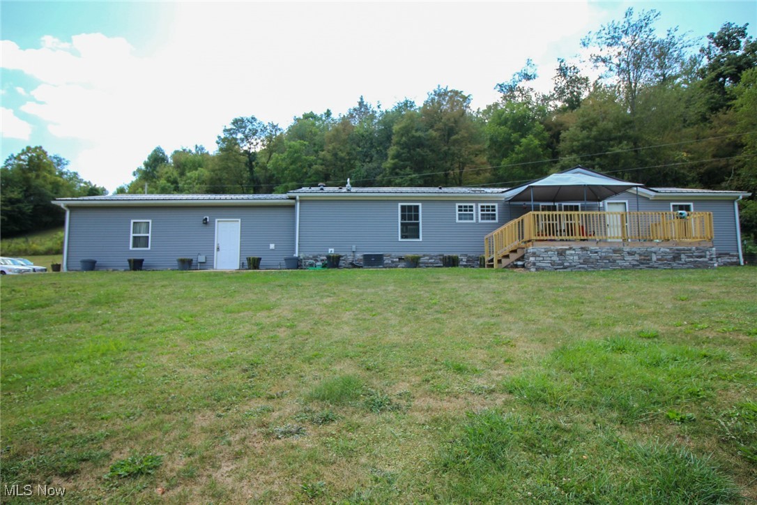 1798 Campbell Road Southwest New Philadelphia, OH 44663 - Photo 2 of 50 Rear view of property featuring a yard, a deck, and a gazebo