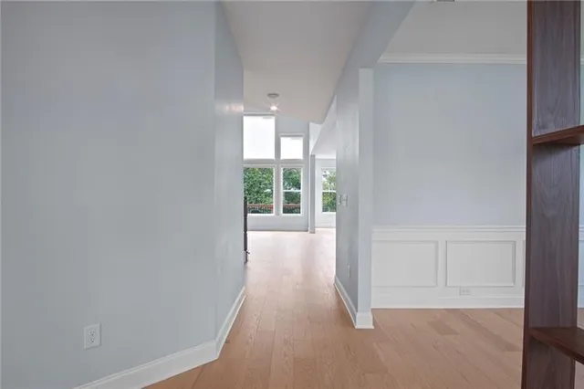 a view of an empty room with window and fire place