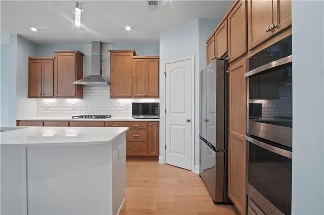a view of a kitchen with a sink and an entryway