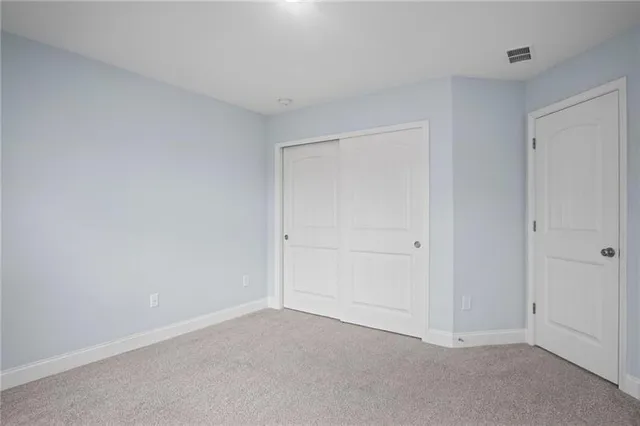 a view of an empty room with stairs