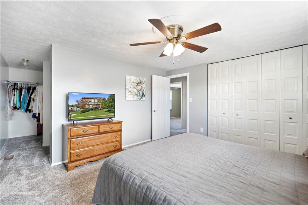 320 Celestial Drive Freedom, PA 15042 - Photo 20 of 28 a bedroom with a bed and a chandelier