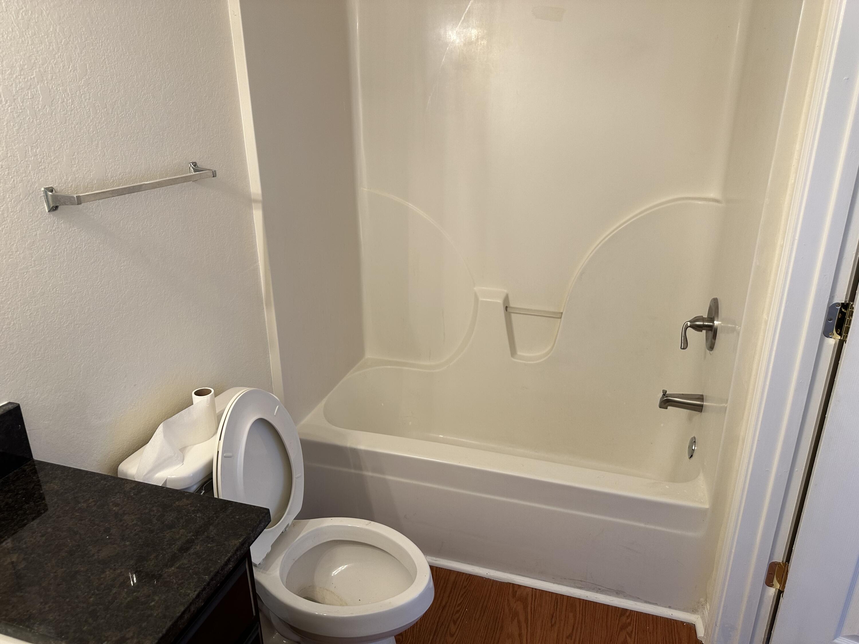 1150 Airport Road, Unit 138 Destin, FL 32541 - Photo 13 of 16 a bathroom with a granite countertop sink toilet and shower