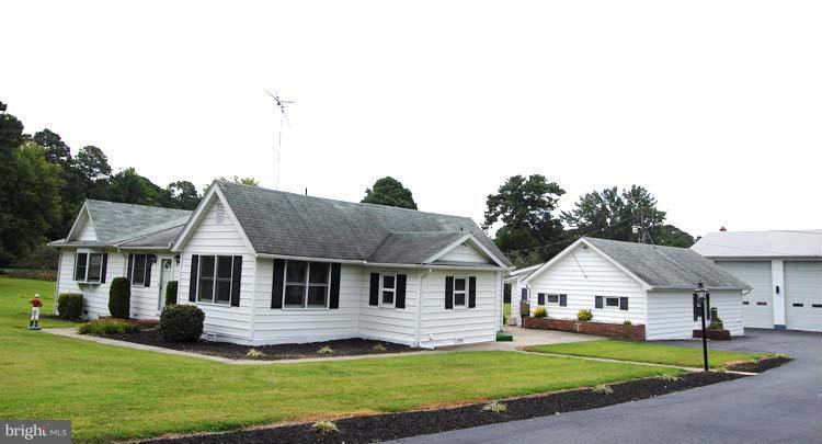 38141 Dukeharts Coltons Point, MD 20626 - Photo 2 of 25 a front view of a house with a garden and yard
