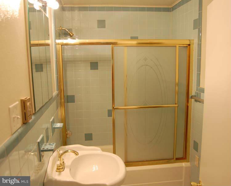 38141 Dukeharts Coltons Point, MD 20626 - Photo 12 of 25 a bathroom with a sink and a mirror