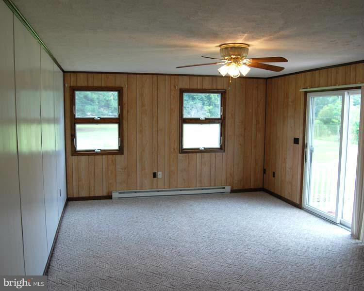 38141 Dukeharts Coltons Point, MD 20626 - Photo 14 of 25 an empty room with chandelier fan and windows