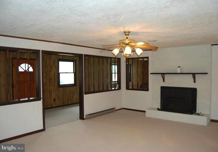 38141 Dukeharts Coltons Point, MD 20626 - Photo 18 of 25 an empty room with chandelier fan and windows
