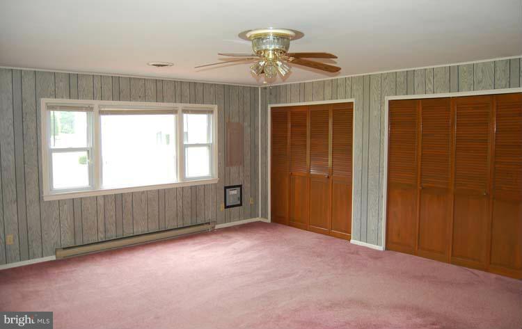 38141 Dukeharts Coltons Point, MD 20626 - Photo 22 of 25 an empty room with chandelier fan and windows