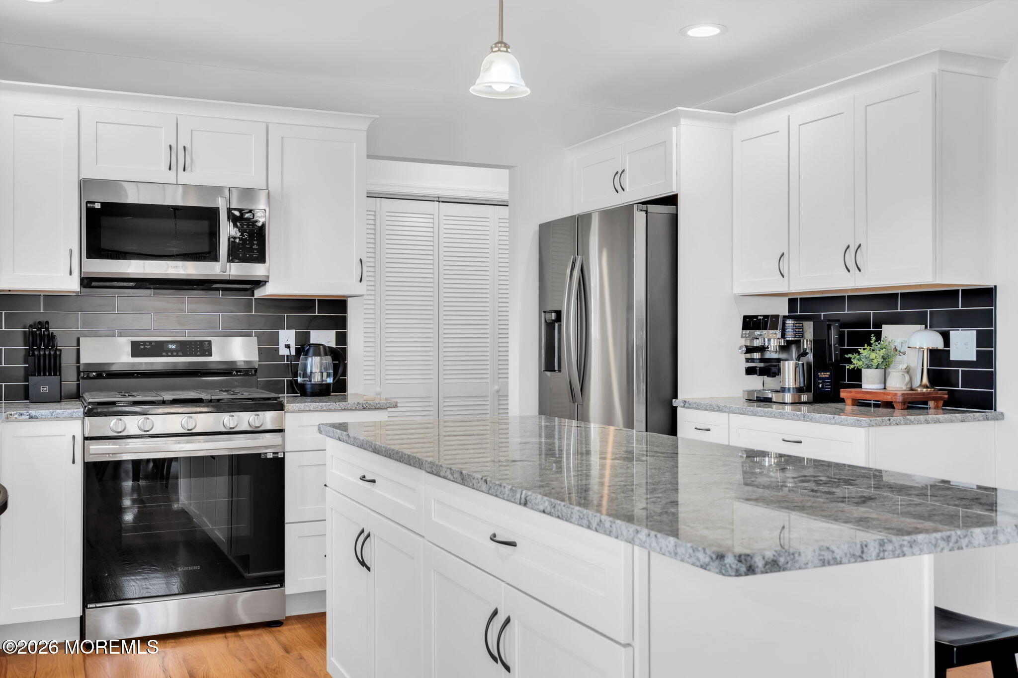 312 Beach Boulevard Forked River, NJ 08731 - Photo 17 of 40 a kitchen with stainless steel appliances granite countertop a stove a refrigerator and a sink