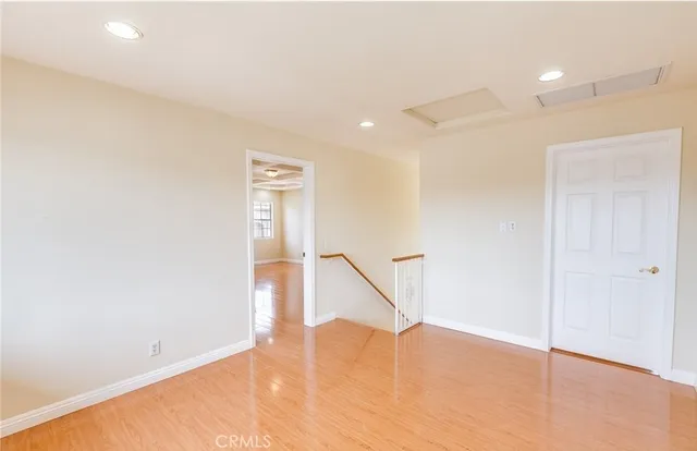 a view of an empty room with wooden floor