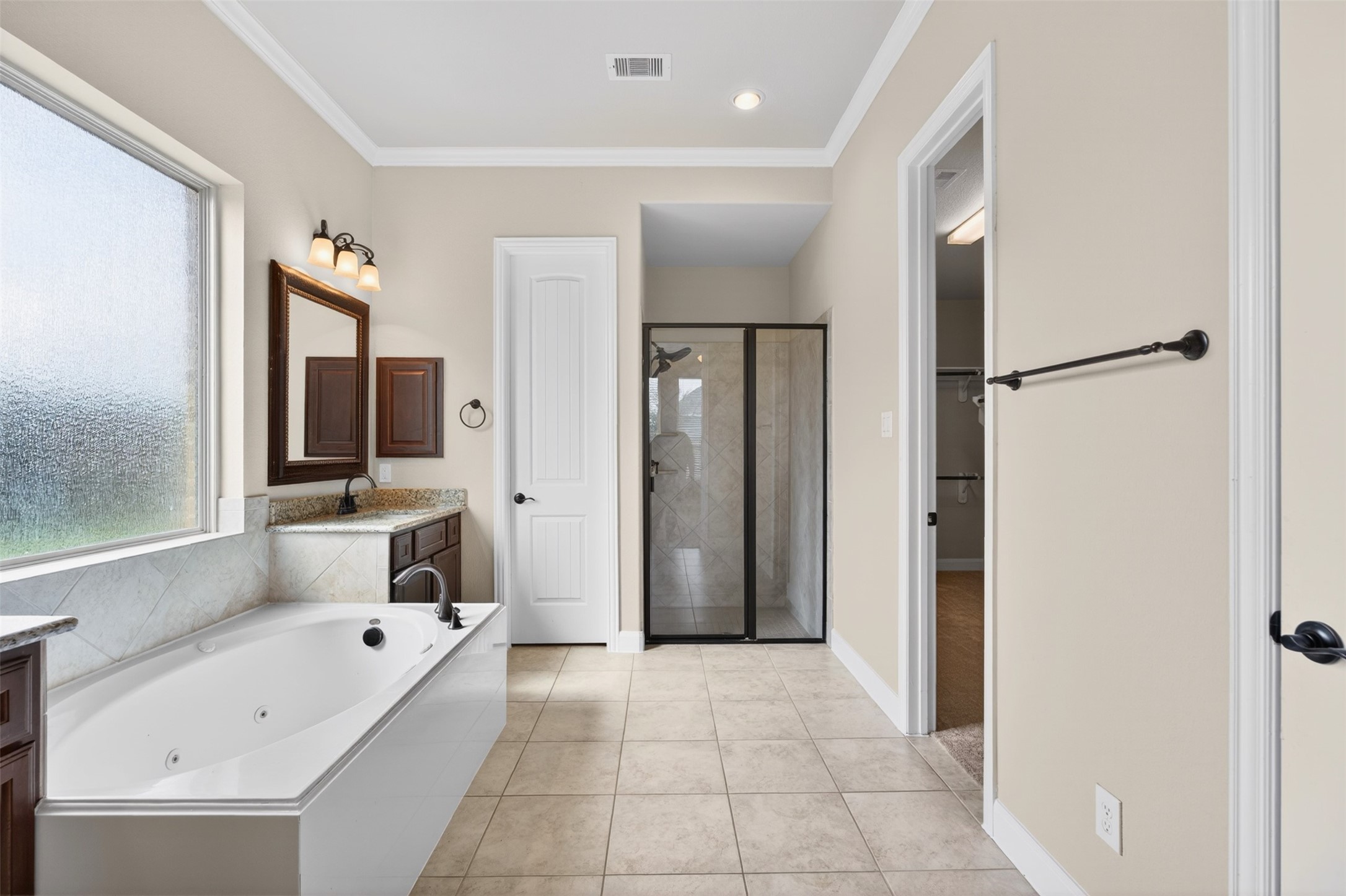18202 Wedgewood Bluff Court Spring, TX 77379 - Photo 28 of 50 Primary bathroom with soaking tub, separate shower, and long vanity area.