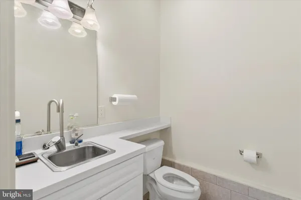 a front view of a house with a garden and trees