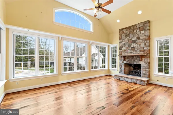 a view of a house with a big yard and large trees