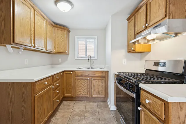 a kitchen with stainless steel appliances granite countertop a sink and cabinets