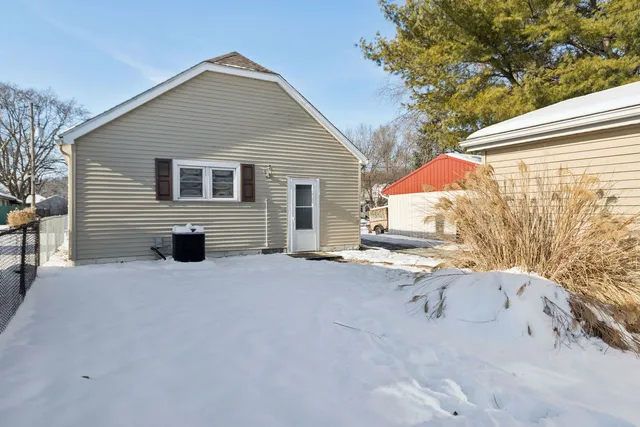 a backyard of a house with table and chairs