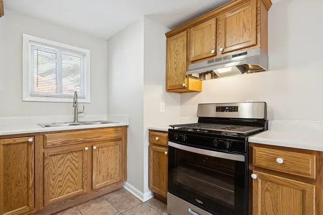 a kitchen with stainless steel appliances granite countertop a stove and a sink