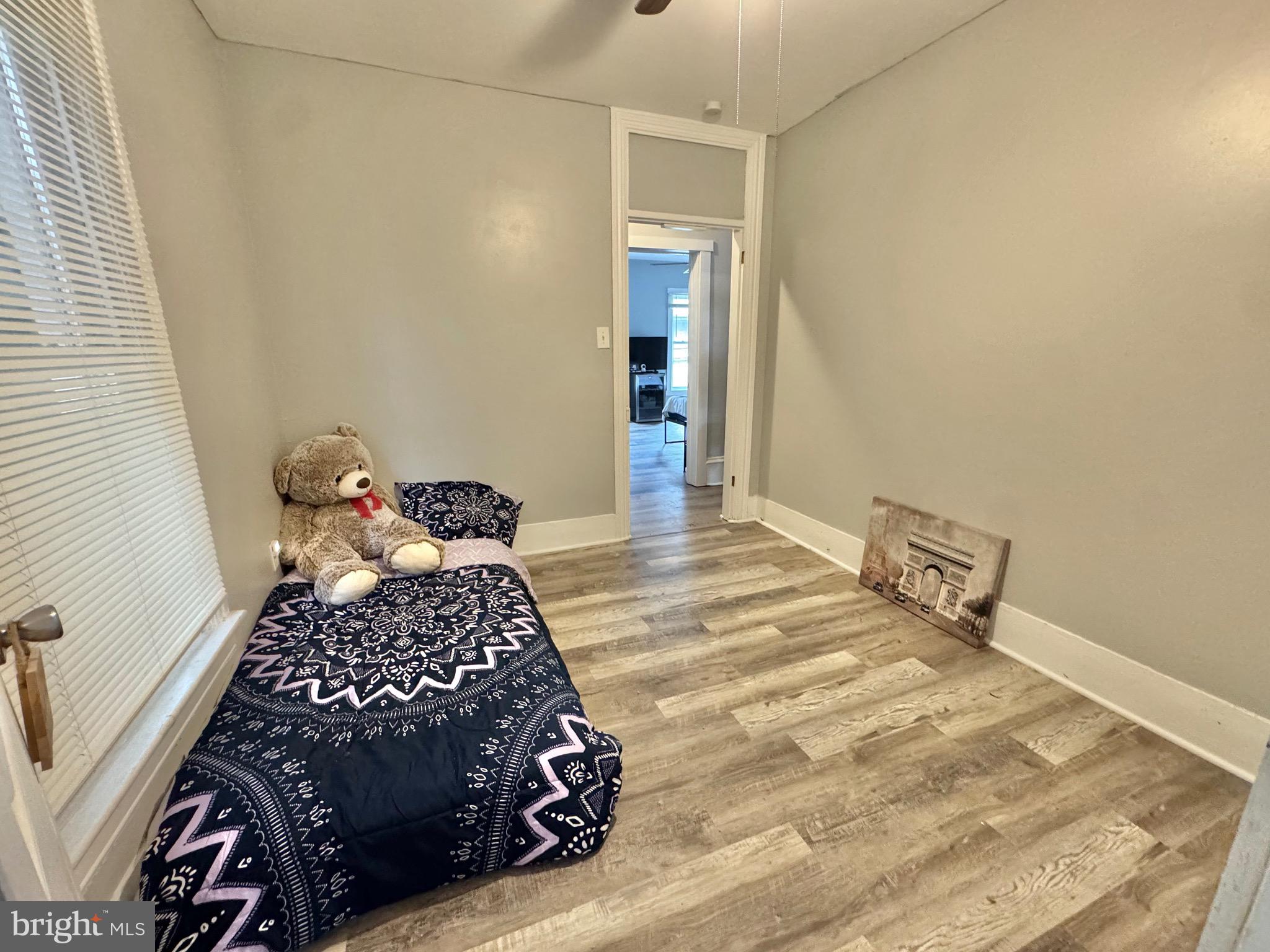 622 Washington Avenue Tyrone, PA 16686 - Photo 13 of 25 a bedroom with a bed and wooden floor