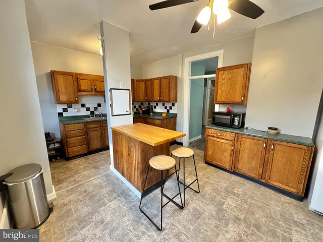 a kitchen with sink cabinets and stove top oven
