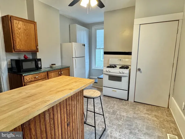 a kitchen with stainless steel appliances a refrigerator and a stove top oven