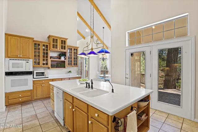 a kitchen with a sink a stove and a refrigerator