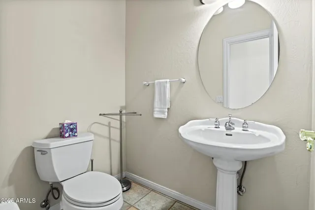 a bathroom with a sink toilet and a mirror