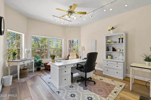 a view of a workspace with furniture and a window