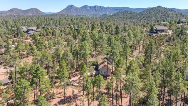an aerial view of a houses with yard