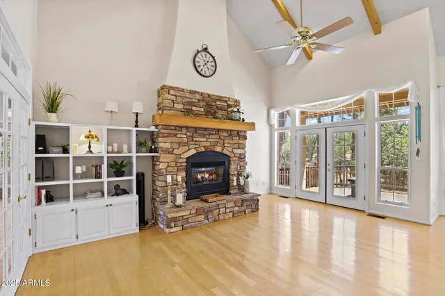 a view of an empty room with a fireplace and a window