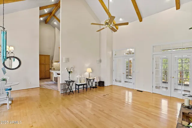 a living room with fireplace furniture and a large window