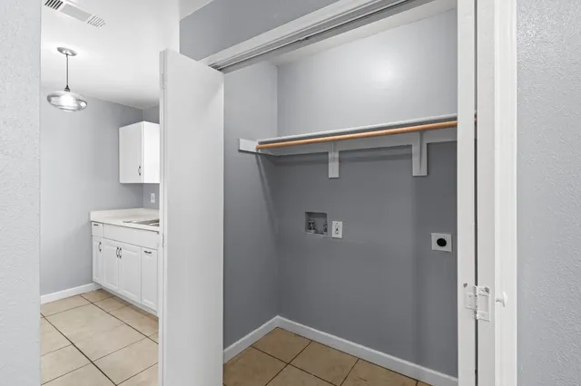 a view of walk in closet with clothes