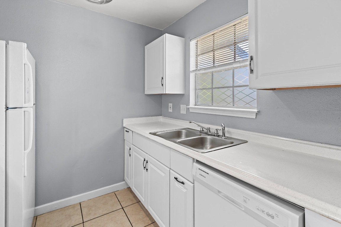 7617 Meador Avenue, Unit B Austin, TX 78752 - Photo 14 of 21 a kitchen with appliances cabinets a sink and a window