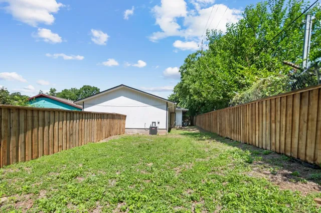 a view of backyard with garden and deck