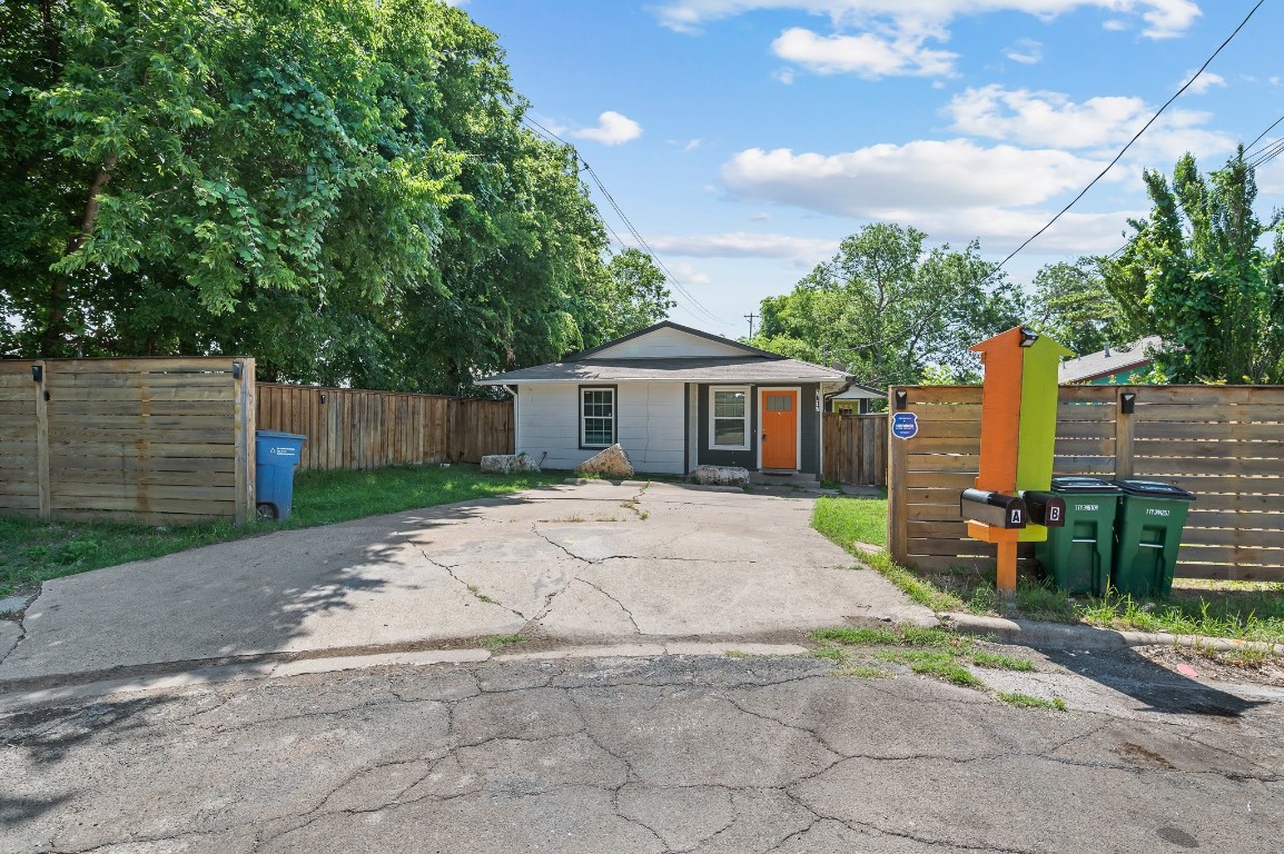 7617 Meador Avenue, Unit B Austin, TX 78752 - Photo 2 of 21 a front view of a house with a garden and trees