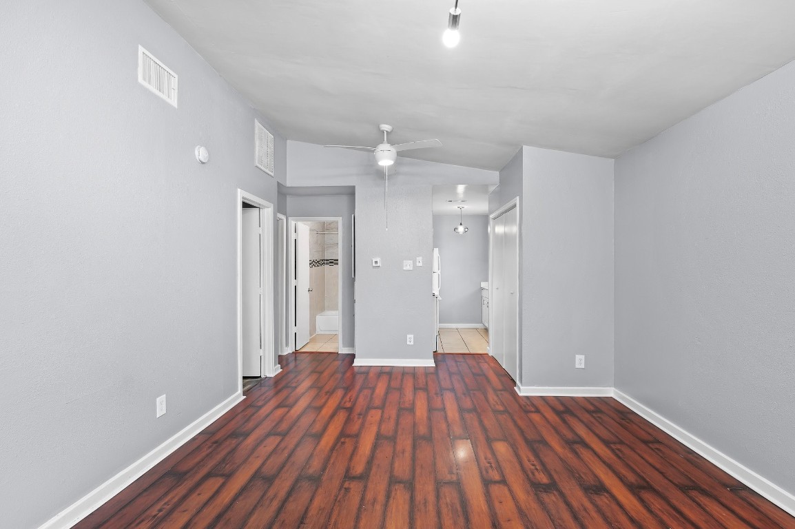 7617 Meador Avenue, Unit B Austin, TX 78752 - Photo 3 of 21 a view of a room with wooden floor and a ceiling fan