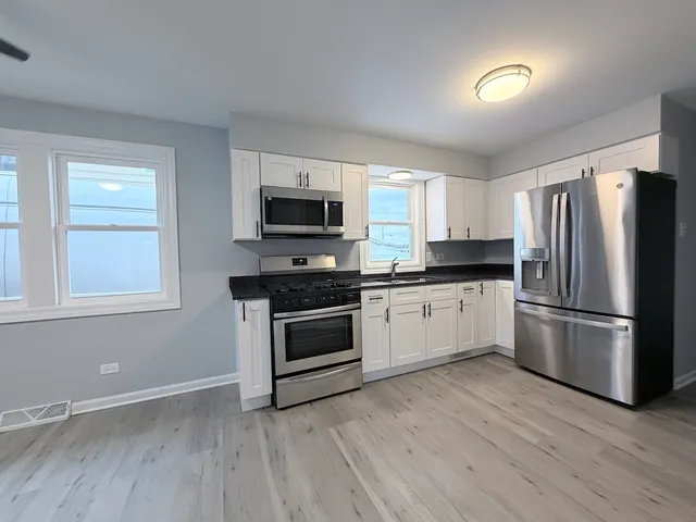 a kitchen with a refrigerator stove and microwave