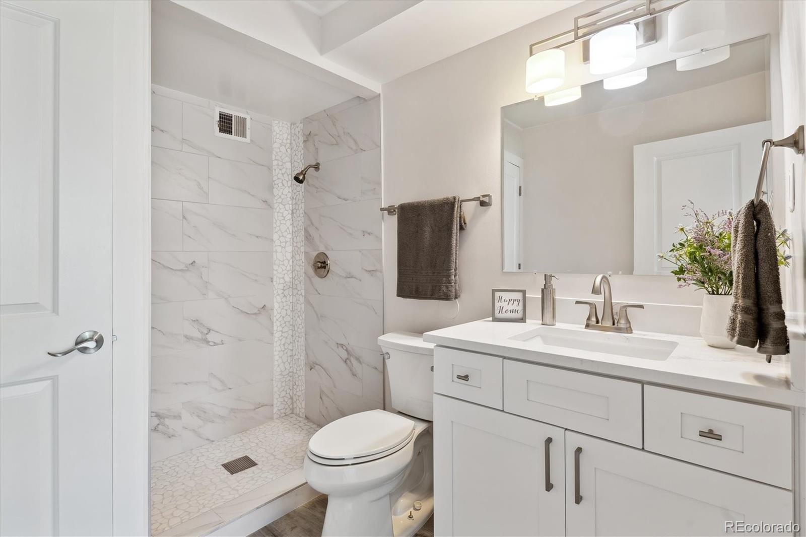 715 South Alton Way, Unit 5A Denver, CO 80247 - Photo 13 of 49 a bathroom with a sink a toilet and shower