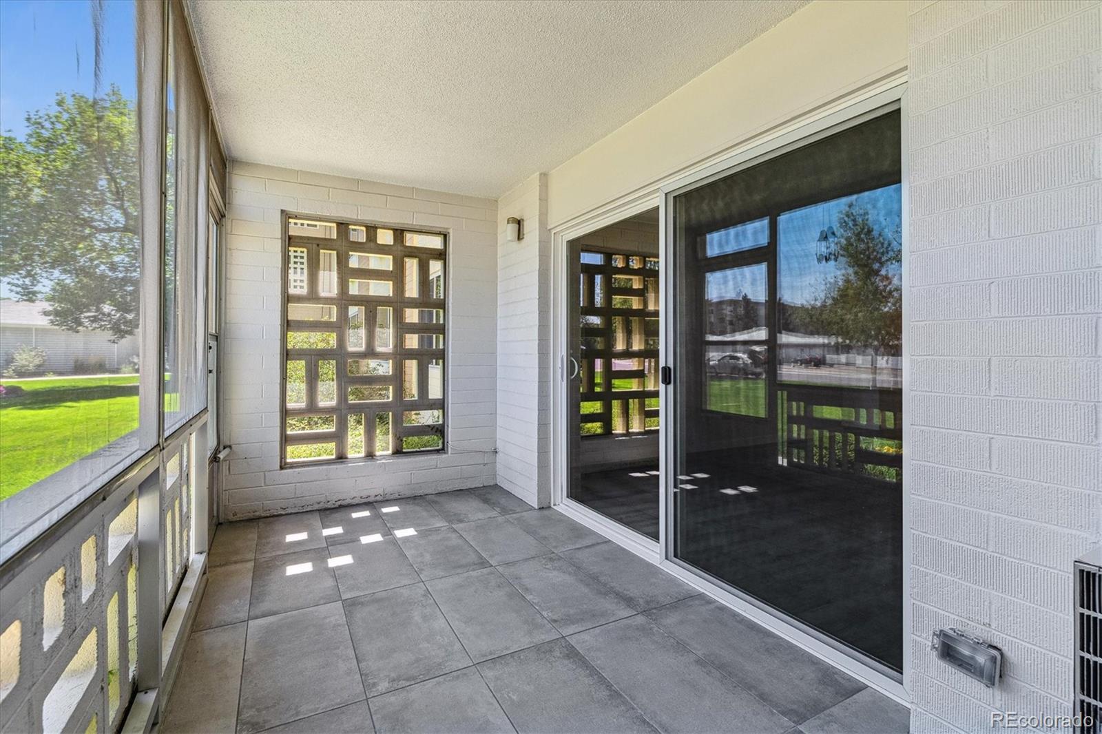715 South Alton Way, Unit 5A Denver, CO 80247 - Photo 19 of 49 a view of an entryway with a garden