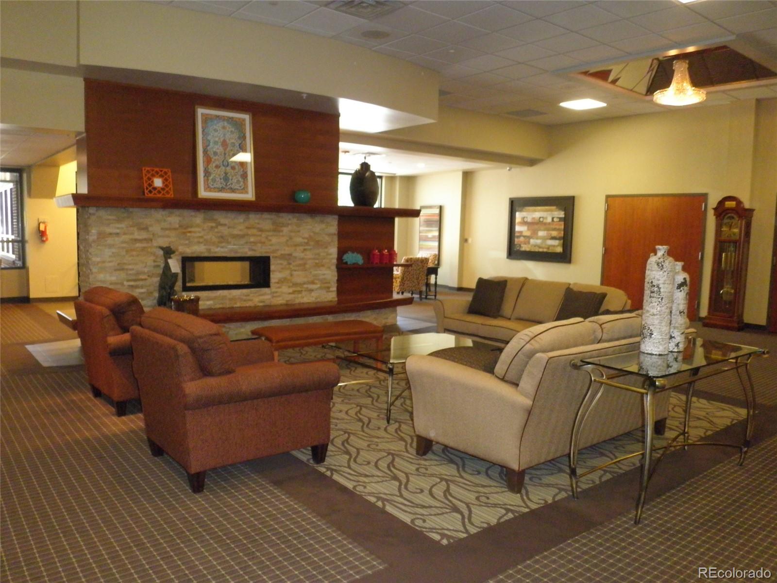 715 South Alton Way, Unit 5A Denver, CO 80247 - Photo 37 of 49 a living room with furniture and a fireplace