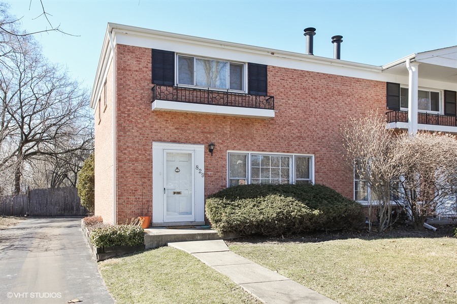 829 Hibbard Road Wilmette, IL 60091 - Photo 1 of 12 a view of a brick house with a yard