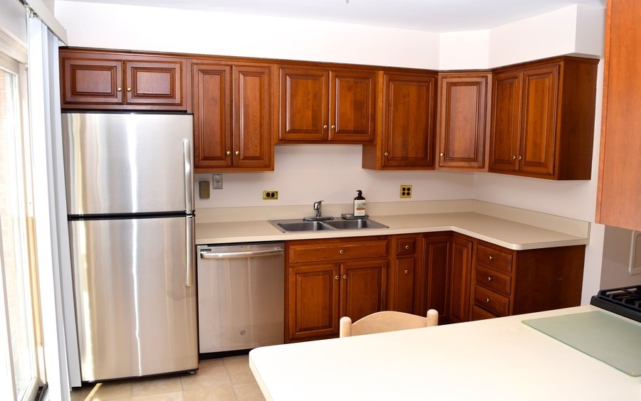 829 Hibbard Road Wilmette, IL 60091 - Photo 4 of 12 a kitchen with stainless steel appliances granite countertop a refrigerator sink and cabinets