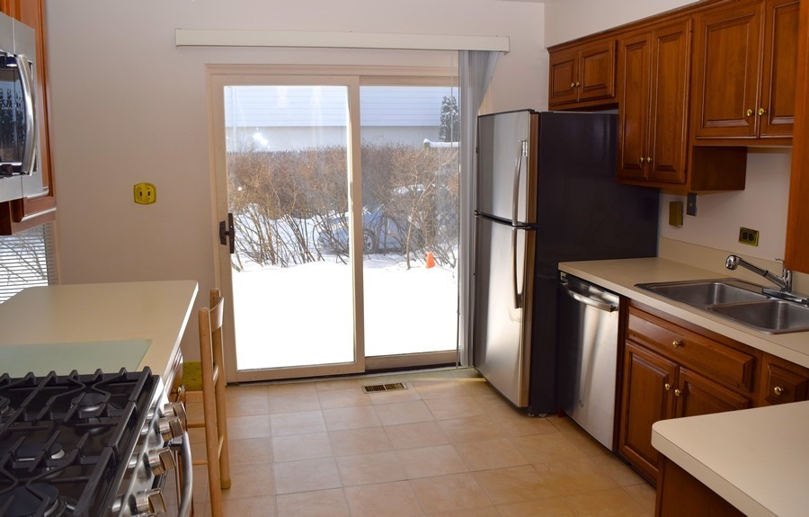 829 Hibbard Road Wilmette, IL 60091 - Photo 5 of 12 a kitchen with stainless steel appliances granite countertop a refrigerator and a stove