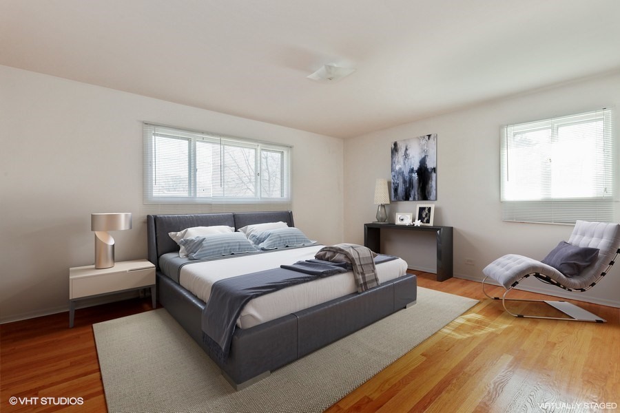 829 Hibbard Road Wilmette, IL 60091 - Photo 8 of 12 a bedroom with a bed and window